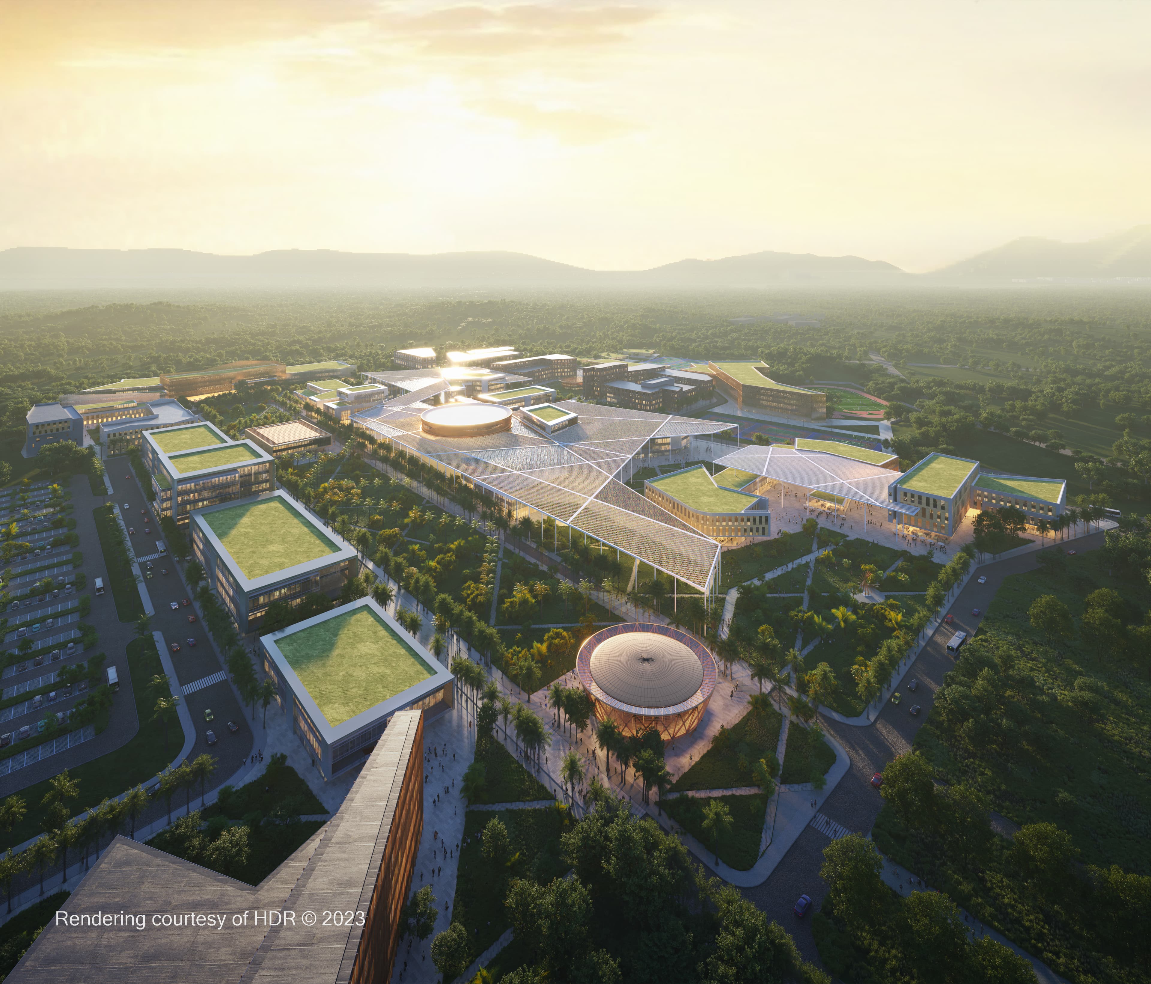 arial photo of a modern and clean looking school campus surrounded by plush forestry